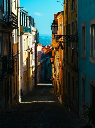 Framed Echoes: The first descent into the heart of Lisbon, where light meets the sea and the path unfolds.