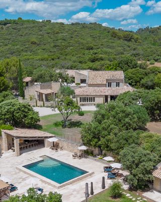 Le Hameau de Sénanque | Private Hamlet with Wellness Space 🧘‍♀️🌲
📍 Gordes · Luberon · Provence
Sleeps 18 · 9 Bedrooms · 9 Bathrooms

In the heart of the Luberon Regional Natural Park, with the Vaucluse mountains in the backdrop and set within four hectares of private pinewood forest, this property is ideally situated within a ten-minute walk of the quintessential Provençal hilltop village center of Gordes.

🏛️ Three distinct buildings, luxurious throughout
Spanning over 440 square meters through three buildings, this luxurious family haven accommodates 18 guests in nine ensuite air-conditioned bedrooms with TV. The main house features a spacious open kitchen leading to a south-facing terrace, complemented by an adjacent office and generous living room. Two bedrooms including the master suite are on the ground floor, with three additional bedrooms upstairs. The first annex, adjacent to the main house, contains two bedrooms and a nearby lounge. The second annex features two bedrooms with an open fully equipped kitchen and lounge area.

🌿 Multi-sports court and wellness space
The garden features a private multi-sports court and pétanque court, while numerous terraces provide shaded havens for dining or enjoying breakfast with family. The well-being space and summer lounge are simply divine for those desiring complete serenity: indoor gym, massage table, sauna, and outdoor lounge area for yoga ensure ample space for relaxation and recreation.

🍷 Peaceful countryside, walkable to Gordes
Located in a peaceful countryside setting, ideally positioned for multi-generational families or groups of friends to enjoy a luxury holiday in Provence.

Start planning your holiday in Provence with a free consultation with one of our Villa Rental Specialists:
https://my.onlyprovence.com/s/property?name=SENANQUE

Weekly rates starting from €17,525.