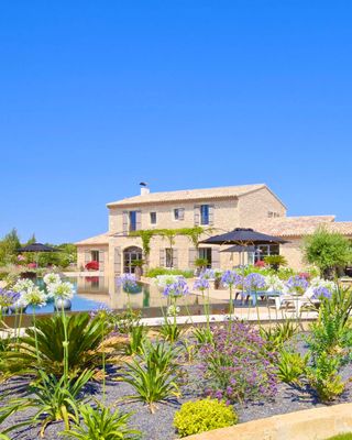 A luxurious newly built farmhouse with mirror pool and Alpilles views, just a 20-minute walk to Saint-Rémy — your upscale escape at Mas la Bohème. 🏔️✨
📍 Saint-Rémy-de-Provence · Alpilles · Provence

Situated on a large private property just three kilometers from Saint-Rémy, this 450-square-meter home features five ensuite bedrooms sleeping up to 10 guests—four in the main house and a fifth with exterior entrance on the other side of the terrace.

High-beamed ceilings, beautiful large windows, and a gorgeous air-conditioned kitchen with full modern amenities overlook the garden. A great amount of attention has been brought to the exterior spaces—terraces, gardens, and mirror swimming pool—ensuring plenty of areas to relax and enjoy the views.

A 20-minute walk through the natural park leads to Saint-Rémy town center with numerous cafés, restaurants, and shops. The peaceful yet chic ambiance and upscale furnishings both indoors and out truly set this property apart.

A luxurious escape in the heart of the Alpilles region.

Contact one of our Villa Rental Specialists to check availability at the link in our bio.

Weekly rates starting from €25,100.